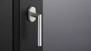 The picture shows the window handle Lucia in stainless steel mounted on a window.