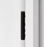 3-part wooden door hinge in the surface graphite black, shown in a white wooden door frame