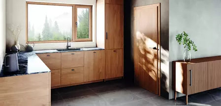 A photo of a modern wooden kitchen with a matching door and window handle that form a harmonious whole