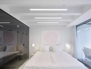 The picture shows the bedroom with a view of the terrace of the VOID concept flat.