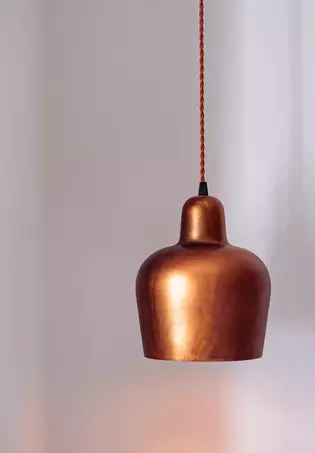 The illustration shows a lamp made of copper.