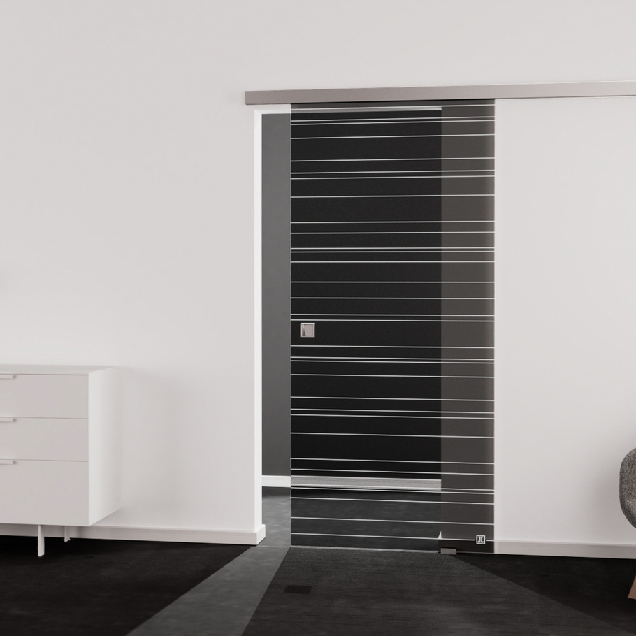 Living situation which shows the glass door with tempered safety glass (ESG) laserdecor JETTE LINES 814 in the vision clear MOON GREY drilling Studio/Office sliding door