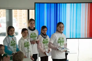 The picture shows five children of different ages wearing the Plant for the Planet T-shirts