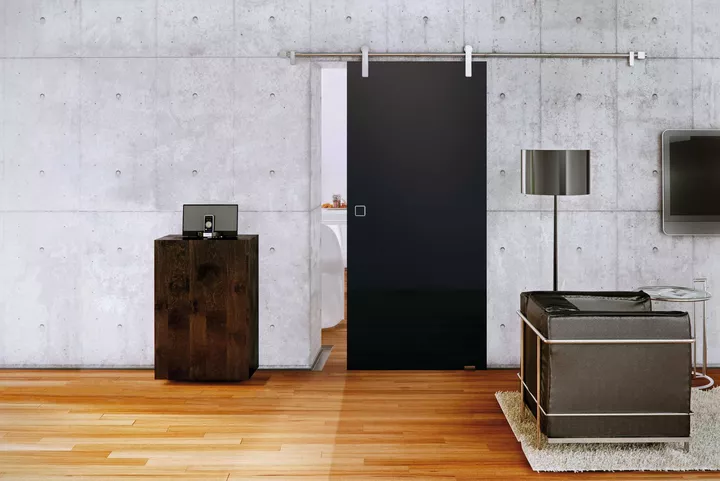 Aluminium sliding door hardware, with rolling cart running visibly on a round tube