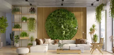 The picture shows a living room with wall greenery. 