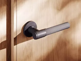 The picture shows the Door handle Aris mounted on a Wooden door.