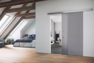 The illustration shows an attic with a Sliding door and the Planeo X Sliding door system.