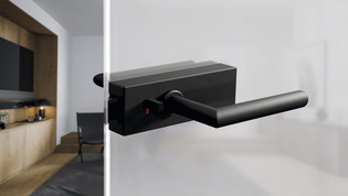 The picture shows the Griffwerk door handle Puristo S with smart2lock in graphite black in a living room.