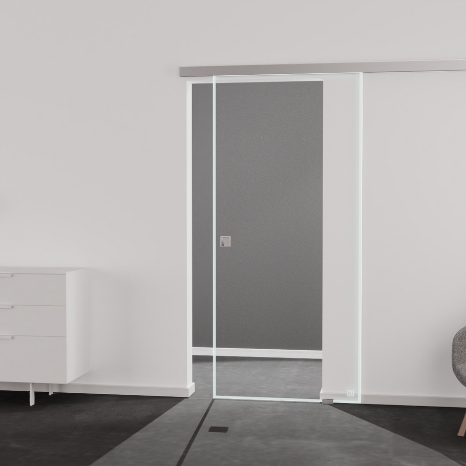 Wohnsituation zeigt die Glastür aus Einscheibensicherheitsglas (ESG) Laserdekor JETTE FRAME 815 in der Ausführung durchsichtig BASIC GREEN Bohrung Studio/Office Schiebetür