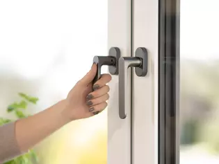Griffwerk window handle Avus cashmere gray with hand Griffwerk window handle Avus in cashmere gray with hand on the handle