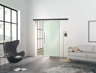 The picture shows a modern living room with the Planeo Air sliding door by Griffwerk on a wall.