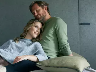 smart2lock - The click to more relaxation A married couple is cuddling in bed and enjoying the peace and quiet. In the background is the door locked with smart2lock, signaling: Now it's time to relax. We have peace and quiet.