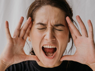 The illustration shows a woman screaming.