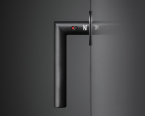 The picture shows the door handle Lucia in graphite black mounted on a black wooden door.