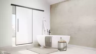 The picture shows the Planeo Air sliding door by Griffwerk in a modern bathroom.