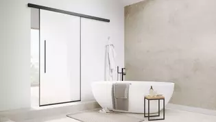 The picture shows the Planeo Air sliding door by Griffwerk in a modern bathroom.