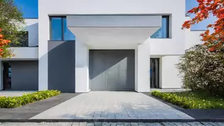 The picture shows the front view with front door of a modern house.