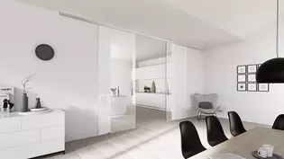 Die Abbildung zeigt die Griffwerk Glasschiebetür Planeo in einem Wohnraum.