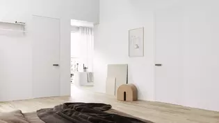 The picture shows a bedroom with a view of the open bathroom, the doors in this room are equipped with the door handle R8 ONE smart2lock in cashmere gray.