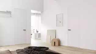 The picture shows a bedroom with a view of the open bathroom, the doors in this room are equipped with the door handle R8 ONE smart2lock in cashmere gray.
